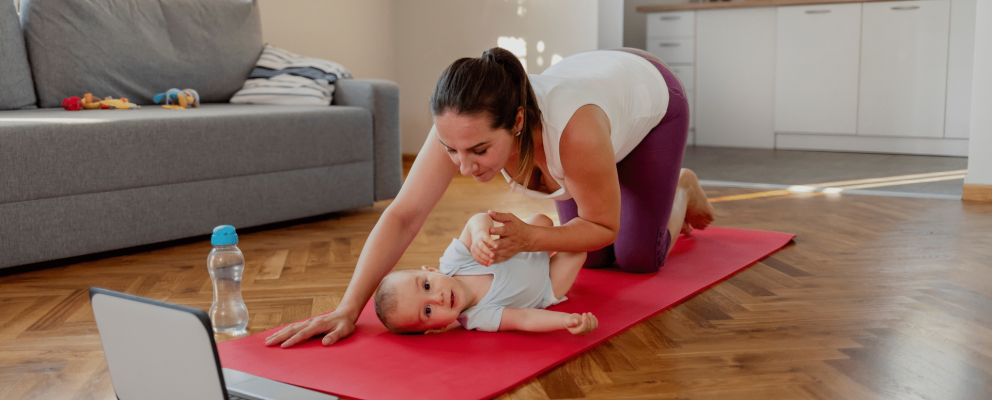 mum with baby on yoga mate