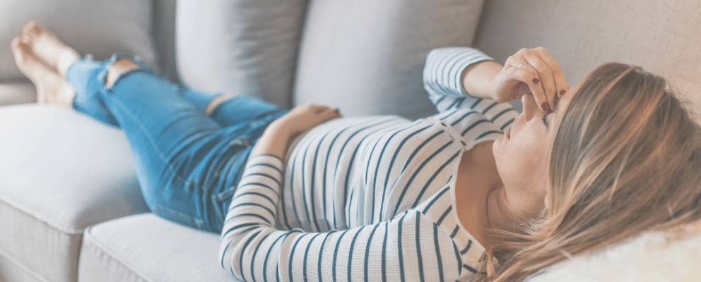 lady laying down due to headache
