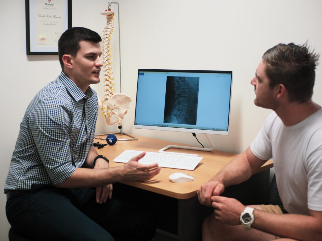 chiropractor explaining spinal x ray