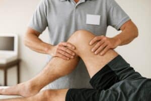 chiropractor hands on treatment on knee