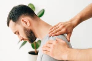 chiropractor feeling patient neck