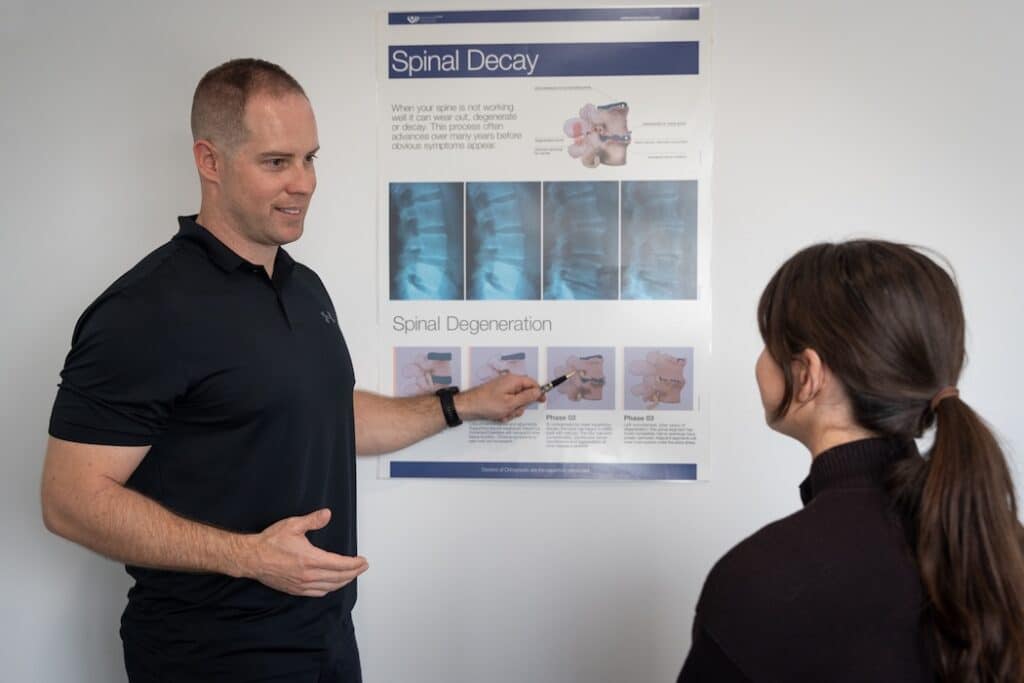 chiropractor taking patient through conditions and injuries