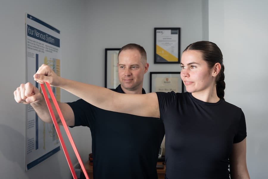 girls doing shoulder exercises with chiropractor