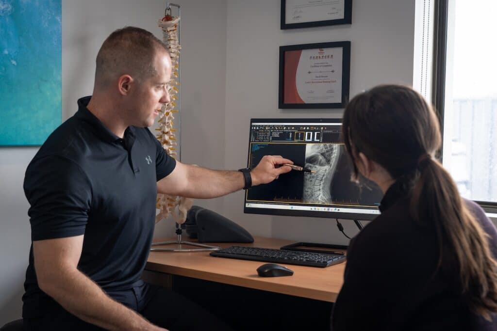 chiropractor looking at xray addressing injury