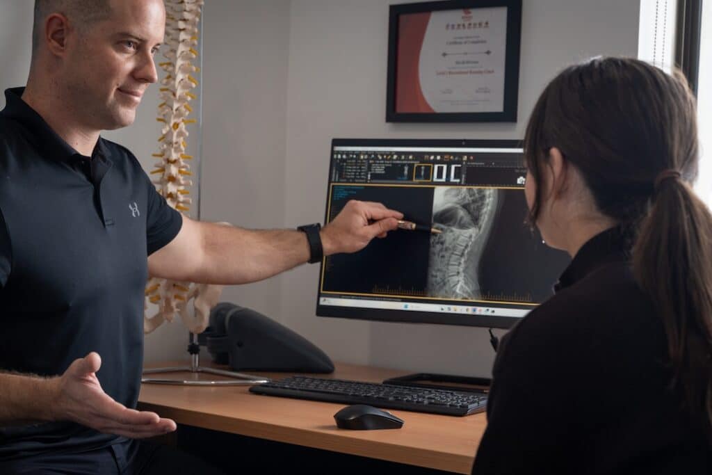 perth chiropractor showing x ray to patient