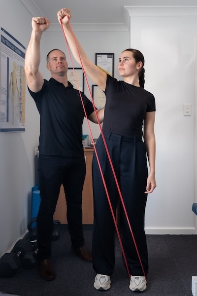 chiropractor doing shoulder rehab due to sports injury