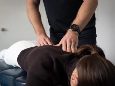 chiropractor pressing top of back