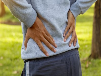 man holding sore lower back