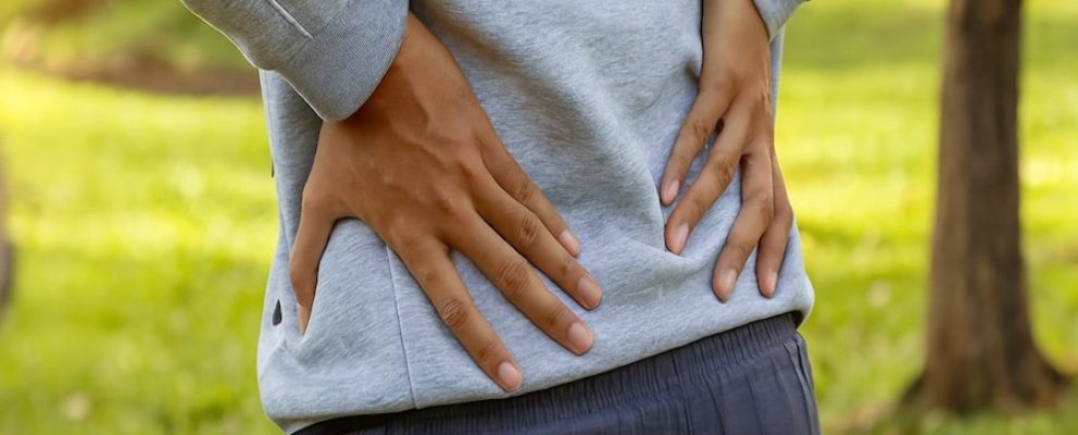 man holding sore lower back